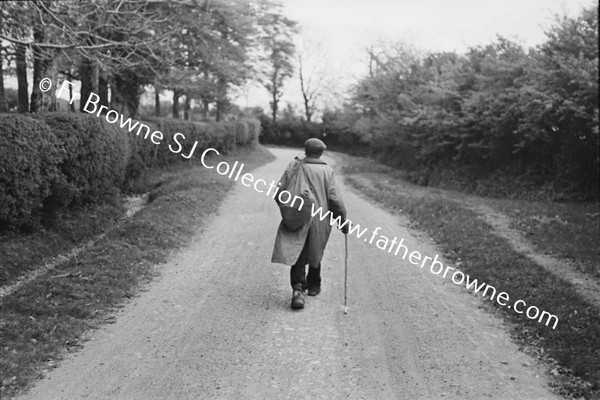 TRAMP WALKING ALONG ROAD